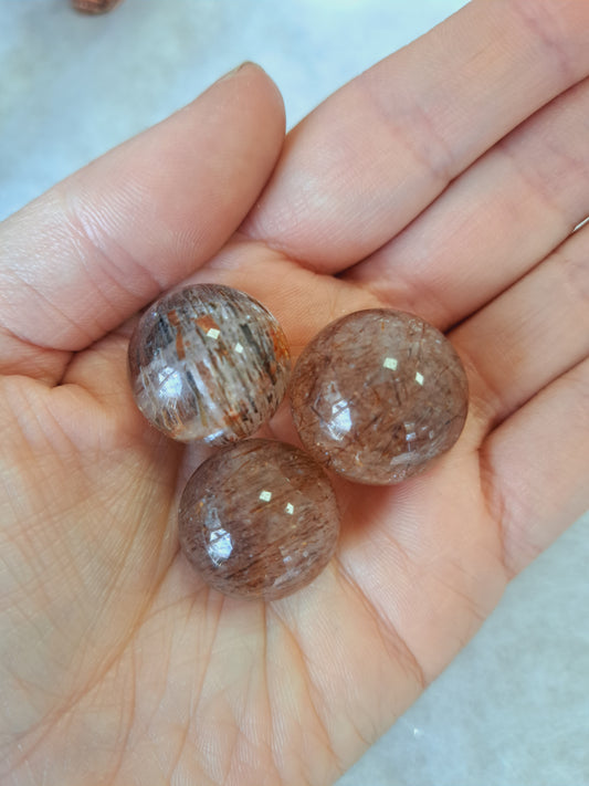 Small rutilated quartz sphere
